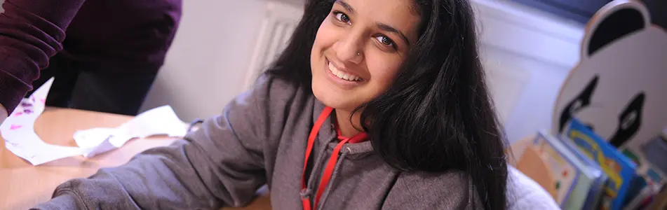 Student in classroom smiling